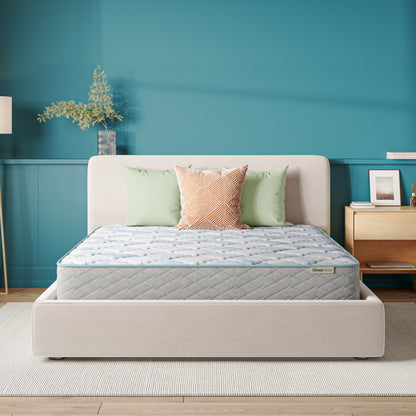 Beautysleep Mattress in a grey bedframe with 3 pillows on top of it within a bedroom setting