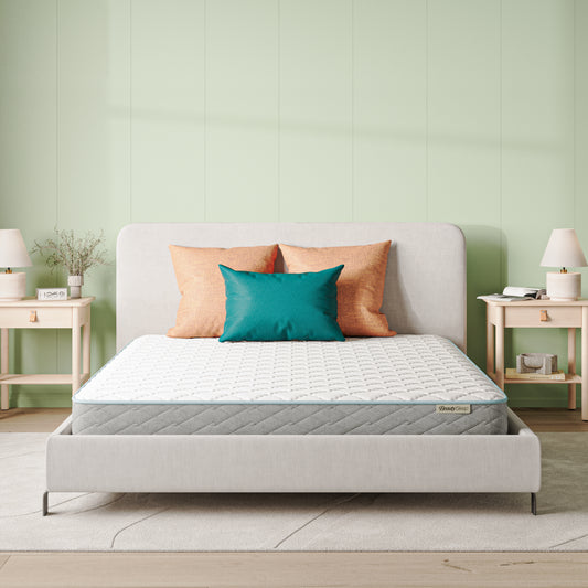 Beautysleep Mattress in a grey bedframe with 3 pillows on top of it within a bedroom setting