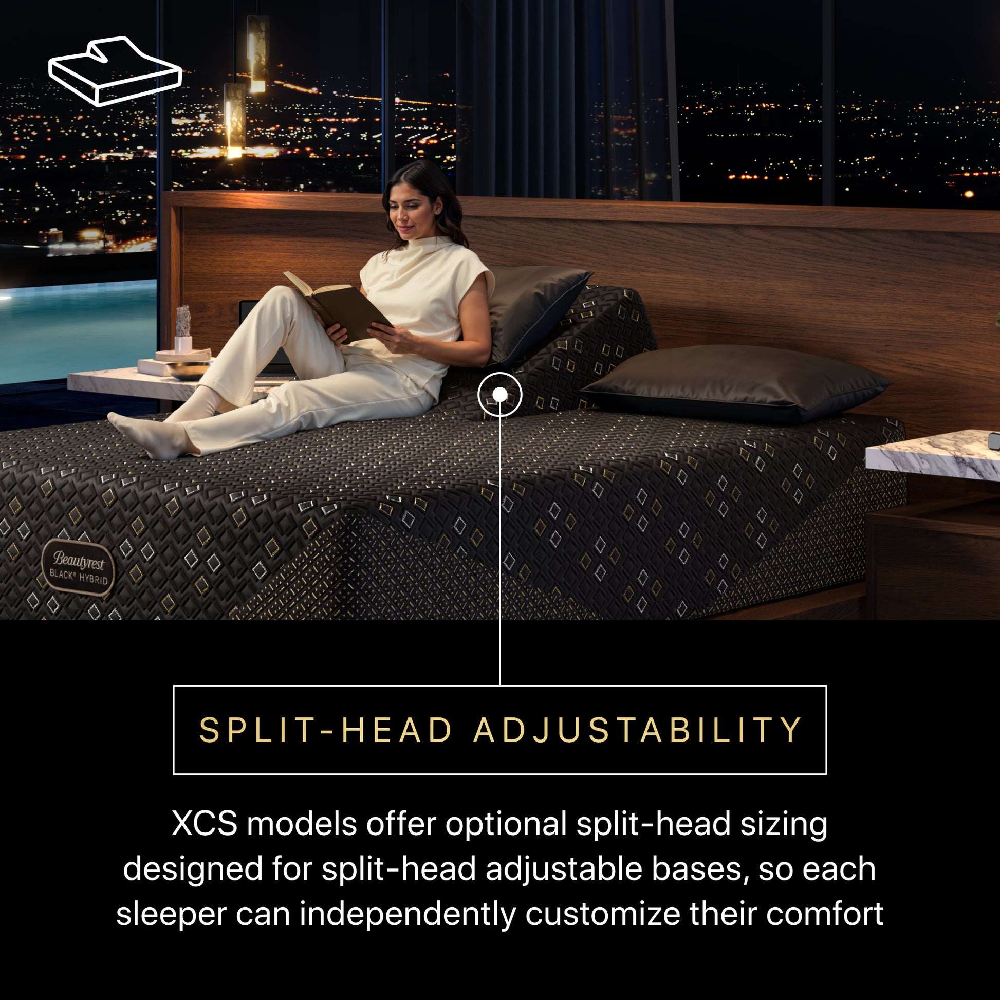 Woman reading a book on a Beautyrest Black Hybid XCS medium  split-head adjustable bed with a cityscape view.