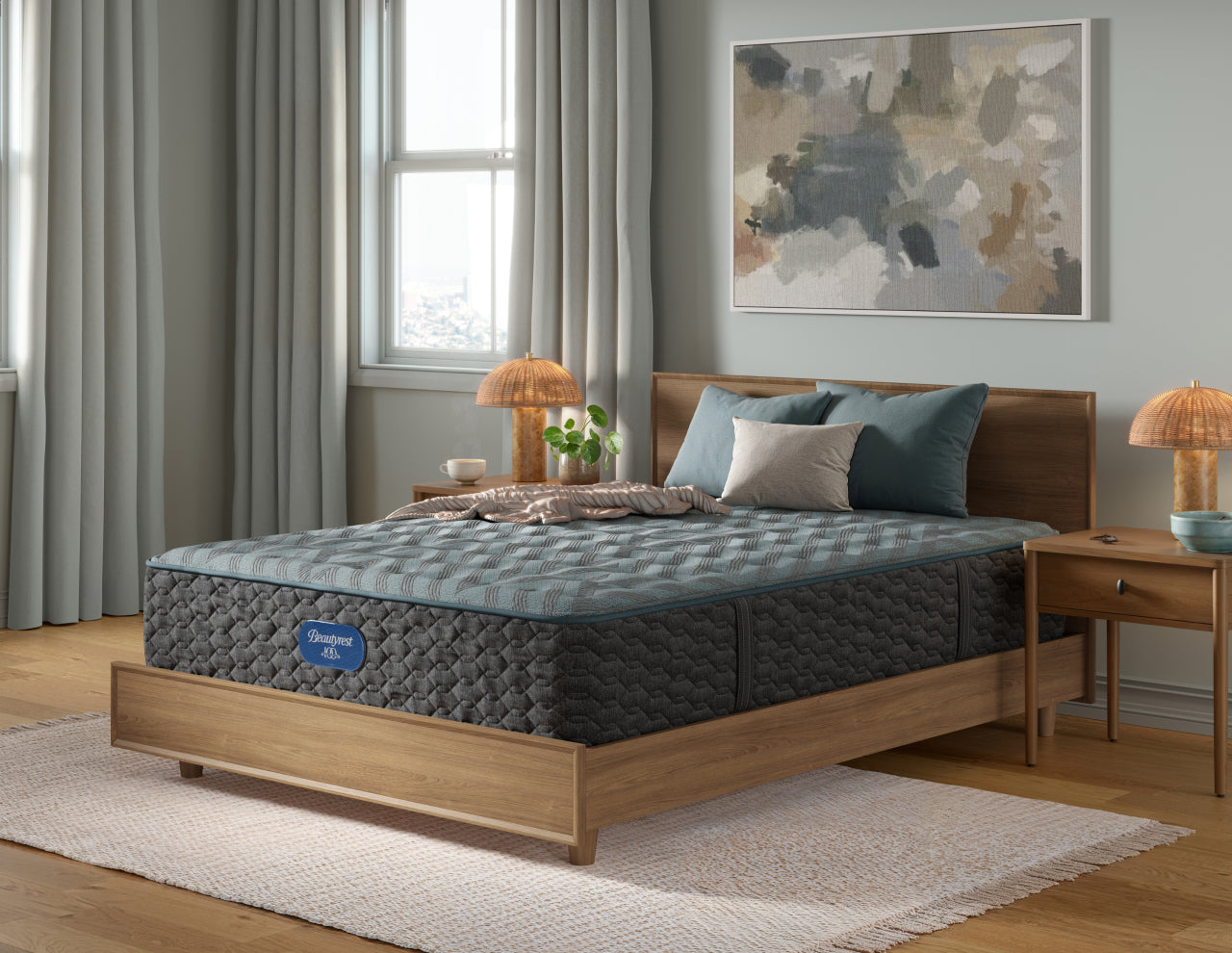 Beautyrest Innerspring Mattress with 3 pillows and a blanket on top of it.