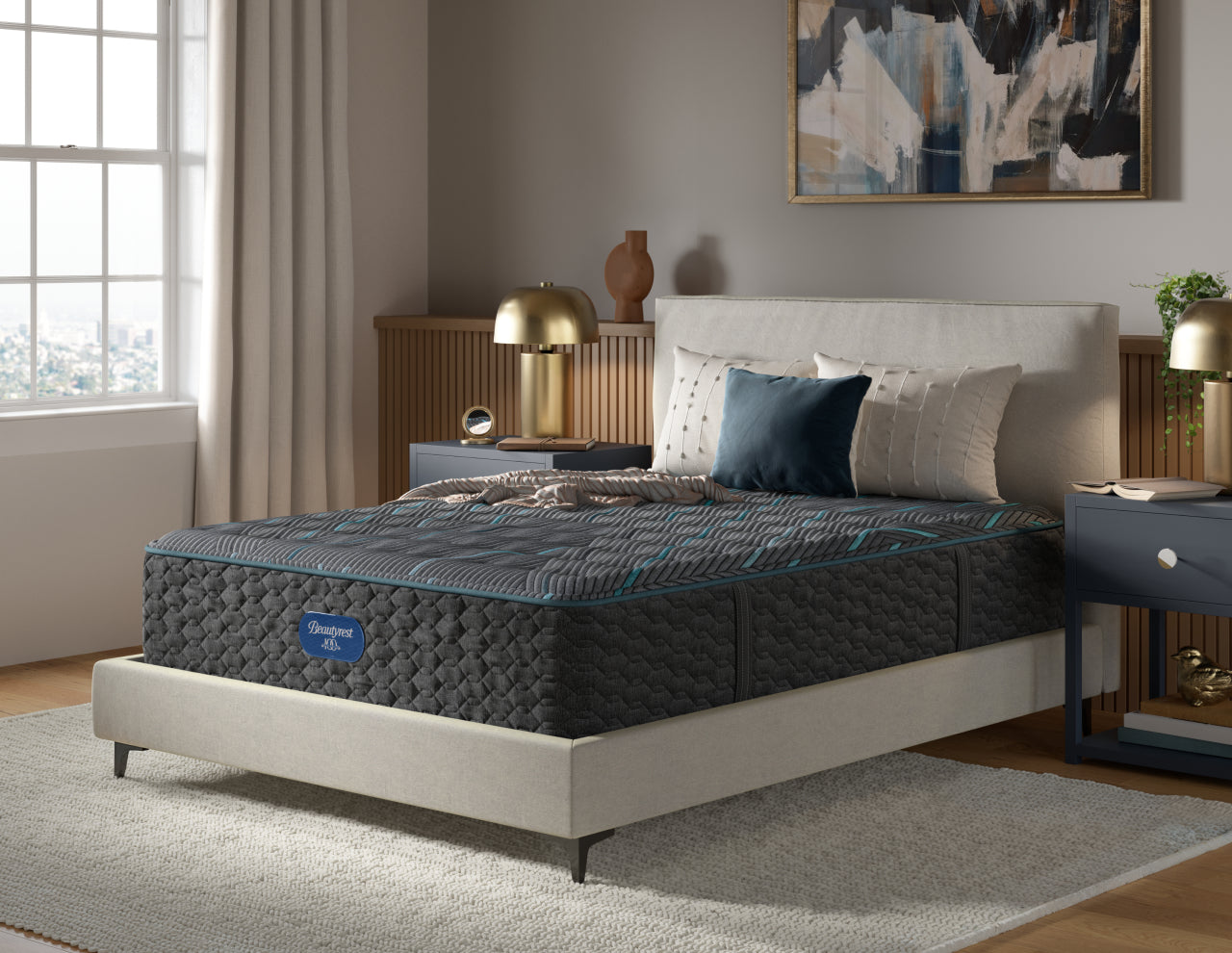 Beautyrest Hybrid Mattress with 3 pillows and a blanket on top of it.