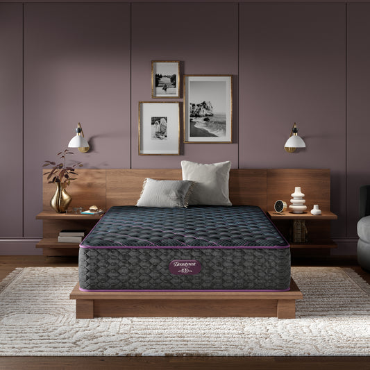 Beautyrest World Class mattress sitting in a brown bed frame with 2 pillows on top of it