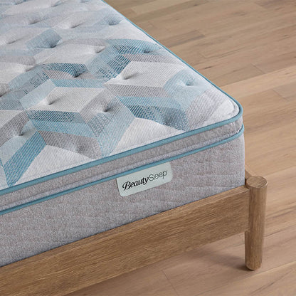 Beautysleep by Beautyrest mattress Gray quilted mattress on a wooden bed frame with 'BeautySleep' branding.